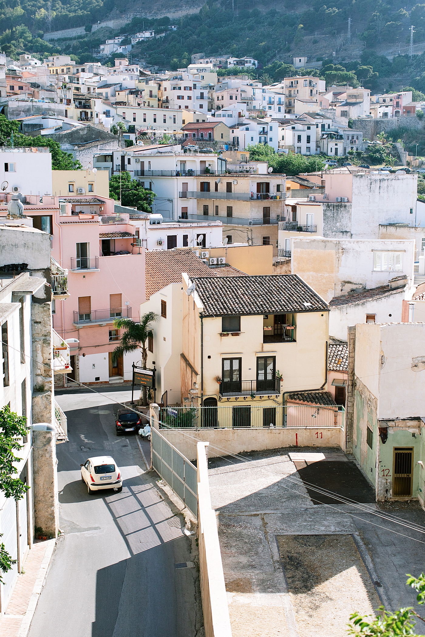 Pastel buildings with an italian car | Photo by Josie Derrick