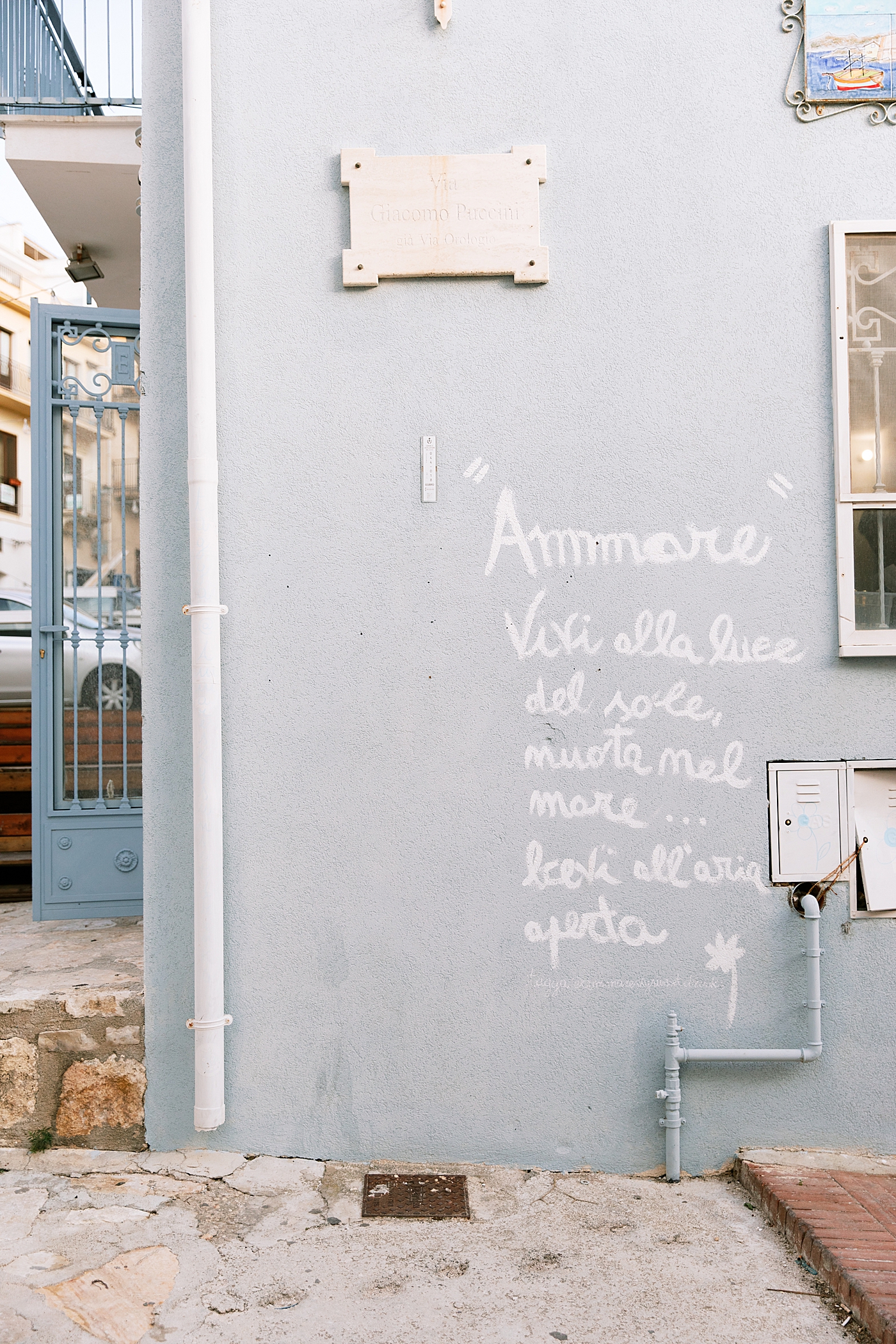 Powder blue building with writing in Castellammare del Golfo | Photo by Josie Derrick 
